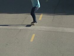 A young man skateboarding in the middle of the street. - Slow Motion Stock Footage