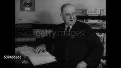 1936: NEW ENGLAND: FISHING INDUSTRY: REPRISAL: Man making telephone call. Elder male in meeting hall making announcement that treaty has been signed w/ no reduction in tariff. Fishermen celebrating. Instructional Video
