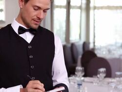 Handsome waiter taking an order Stock Footage