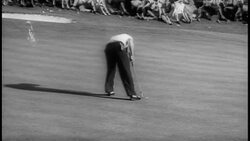 B/W 1958 Arnold Palmer putting ball into hole then shaking hands with Ken Venturi / Masters Stock Footage