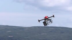 Drone carrying a package across the sky Stock Footage