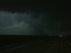 Shot from van, storm chasers stop on road to film large tornado at night. Tornado in the dark. Kansas, USA Stock Footage