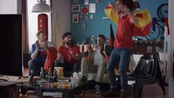 Sport fans sitting on couch watching tv and cheering Stock Footage