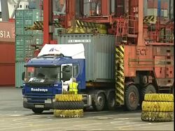 Container being lowered on to lorry, Container Terminal, Southampton, UK Stock Footage