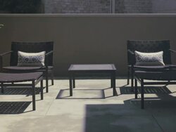 Patterns of light shift across concrete in outdoor patio. Stock Footage