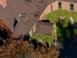 MS AERIAL ZO DS Shot of red house surrounded by tree at Naumkeag Estate / Massachusetts, United States Stock Footage