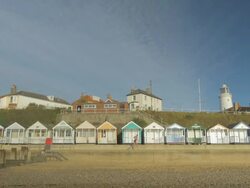 Southwold,colourful beach huts,Jogger,gLighthouse,MS Stock Footage