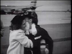 B/W 1960s soldier + woman walking while hugging + kissing / Vietnam War homecoming / CA Stock Footage