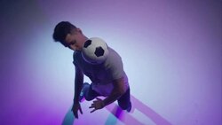 young male soccer freestyler throwing a ball with his head Stock Footage