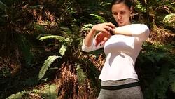 A young women running, working out, stretching and checking her mobile device outdoors on a sunny day. Stock Footage