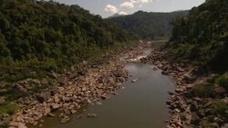 A narrow river flows between rocky, forested hills. Stock Footage