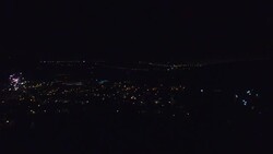 People celebrating the summer solstice in Catalonia at night with fireworks and bonfires in the city streets taken from elevated viewpoint. Stock Footage