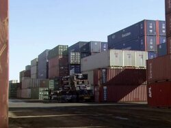 MS forklift lifting container and moving in front of containers / Los Angeles, California, United States Stock Footage