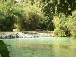 MS SLO MO Shot of Small waterfalls with lush vegetation all around / Kuang Si, Luang Prabang, Laos Stock Footage