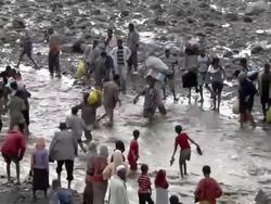 People crossing river after bridge fell down Stock Footage