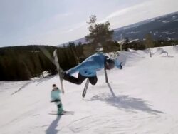 A skier doing a jumping trick on skis in the winter at a ski resort. - Slow Motion Stock Footage