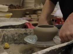 Potter taking finished pot off wheel Stock Footage