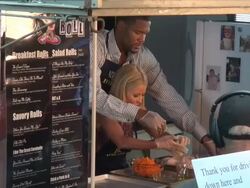 Kelly Ripa and Michael Strahan prepare a chicken for cooking on the outside set of the Live with Kelly & Michael show in New York, NY, on 7/11/13. (Getty Images Entertainment Video) Stock Footage
