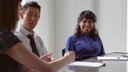 MS Smiling businessman and businesswoman listening to coworker during team meeting in office conference room Stock Footage