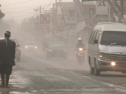 Men try and clear ash off streets of Yogjakarta after eruption of Merapi volcano; Central Java, Indonesia. 30 October 2010 / AUDIO Stock Footage