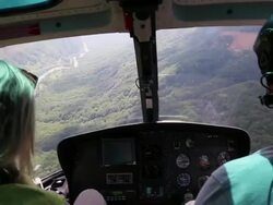 Woman flies in helicopter alongside pilot, takes pictures Stock Footage