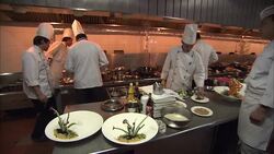 A restaurant chef tastes a small plate of food in a busy kitchen. Stock Footage
