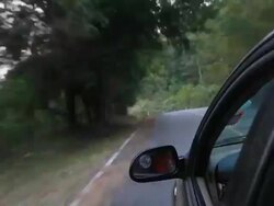 Driving car down hill with winding road bends, time lapse Stock Footage
