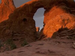 Turret Arch with dramatic morning sunshine and shadows across it's face - tilt up Stock Footage