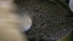 A spoon smooths caviar into a tin. Stock Footage