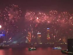 Fireworks shoot up and explode from floating barges in Hong Kong's Victoria Harbour, view from Tsim Sha Tsui towards Hong Kong Island East Asian Games Opening Ceremony Fireworks Display, December 2009 Stock Footage