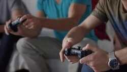 Guys sitting on couch playing video games Stock Footage