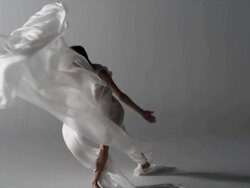 woman with silk draped around her, fabric blows in wind Stock Footage