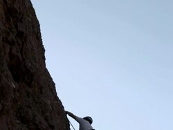 Man rock climbing and cheering Stock Footage