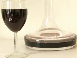 Glass of red wine and carafe Stock Footage