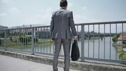 Yuppie rejoicing a good news on the bridge Stock Footage