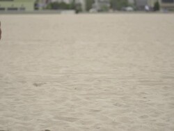 A man doing speed and agility training with parachutes on the beach.  - Super Slow Motion - filmed at 240 fps Stock Footage