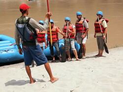 River rafting guide teaching to rafters, Ganges River, Rishikesh, Uttarakhand, India Stock Footage
