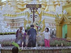MS Shot of Men and women taking water and pouring it over Buddha statue in front of temples / Yangon, Yangon Division, Myanmar  Stock Footage