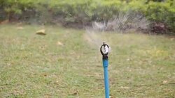 Water sprinkler showering grass.  Part 5 Stock Footage