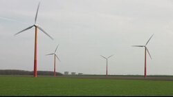 Colourful wind turbines operated by Nuon, near Almere in Flevoland, Netherlands. They are sited on reclaimed polder land that is below sea level. Stock Footage