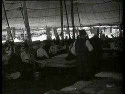 B/W Civil War veterans on cots under tent at reunion / Vicksburg, Mississippi / NO SOUND Stock Footage