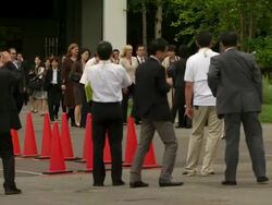 WS PAN Shot of television news crews working outside during G8 meeting / Hokkaido Toyako, Japan Stock Footage