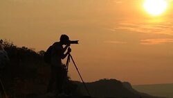 silhouette of women take a photo with mountain at sunset . Stock Footage
