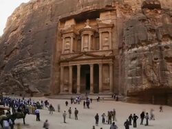 T/L, WS, ZO, fish eye, fast moving people outside the Al Khazneh (Treasury) at ancient stone city of Petra / Jordan Stock Footage