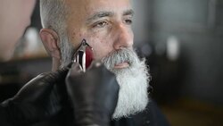 brutal barber clipper mows bearded adult senior hipster Stock Footage
