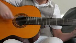 Teenager playing guitar (closeup) Stock Footage