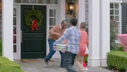 Excited grandfather hurries outside to welcome and hug family for Christmas (dolly-shot) Stock Footage