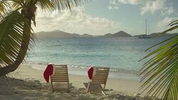 video of chairs with Santa hats at a tropical beach Stock Footage