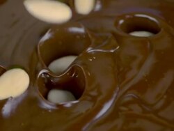 HD Super Slow-Mo: Almonds Splashing Into Chocolate Stock Footage