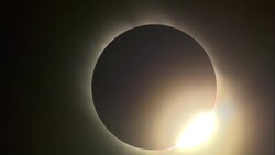 The sun bursts from behind the moon after a total solar eclipse. Stock Footage